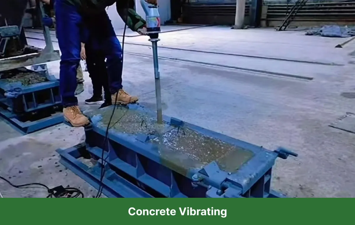 Concrete vibrating process using a mechanical vibrator to remove air bubbles and improve compaction inside the formwork.